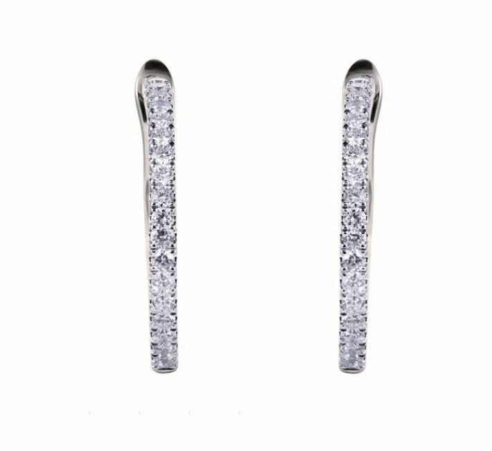 A pair of whote gold huggie hoop earrings with pavé-set clear stones, shown against a plain white background.