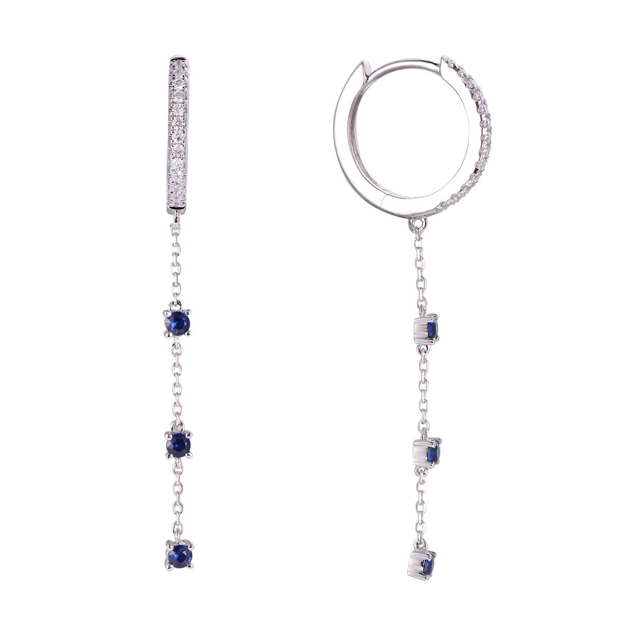 A pair of silver-toned dangle earrings featuring a small hoop on one earring and a barbell-style drop on the other, both adorned with clear stones and blue gemstones, shown on a plain white background.